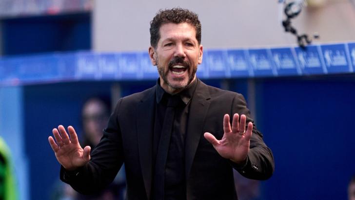 Diego Simeone puts his hands up on the sideline at Atletico Madrid
